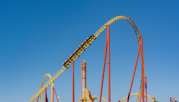 a roller coaster in an amusement park on a clear day