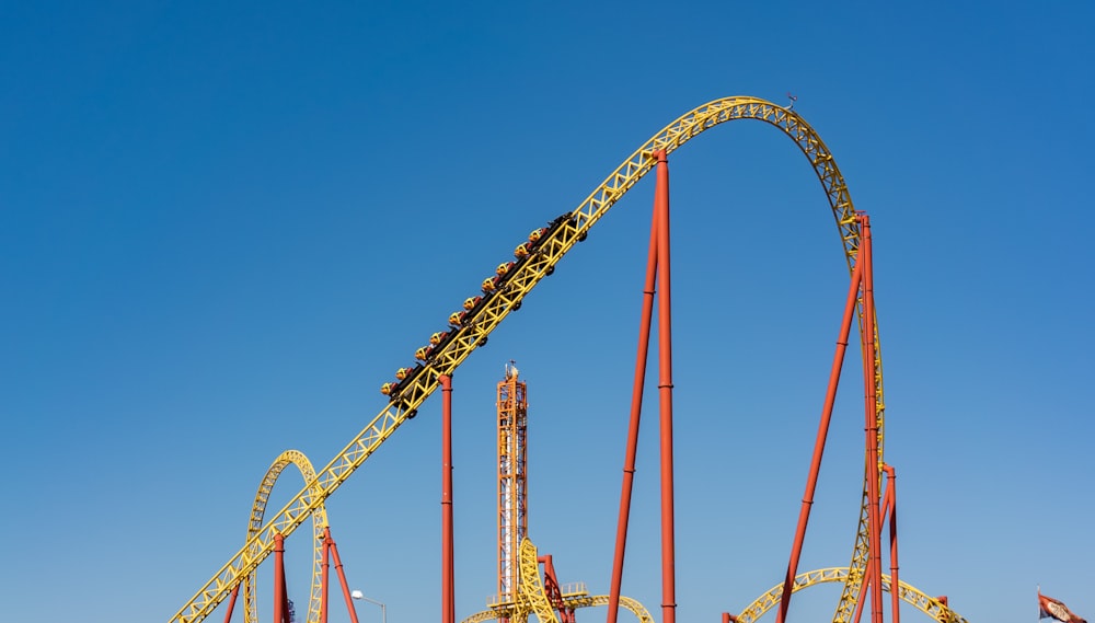 a roller coaster in an amusement park on a clear day