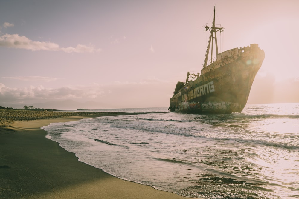 a large ship sitting on top of a sandy beach