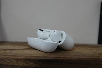 Close-up of wireless earbuds resting in their charging case on a marble surface