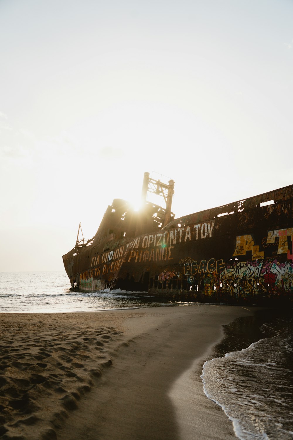 a large ship sitting on top of a sandy beach
