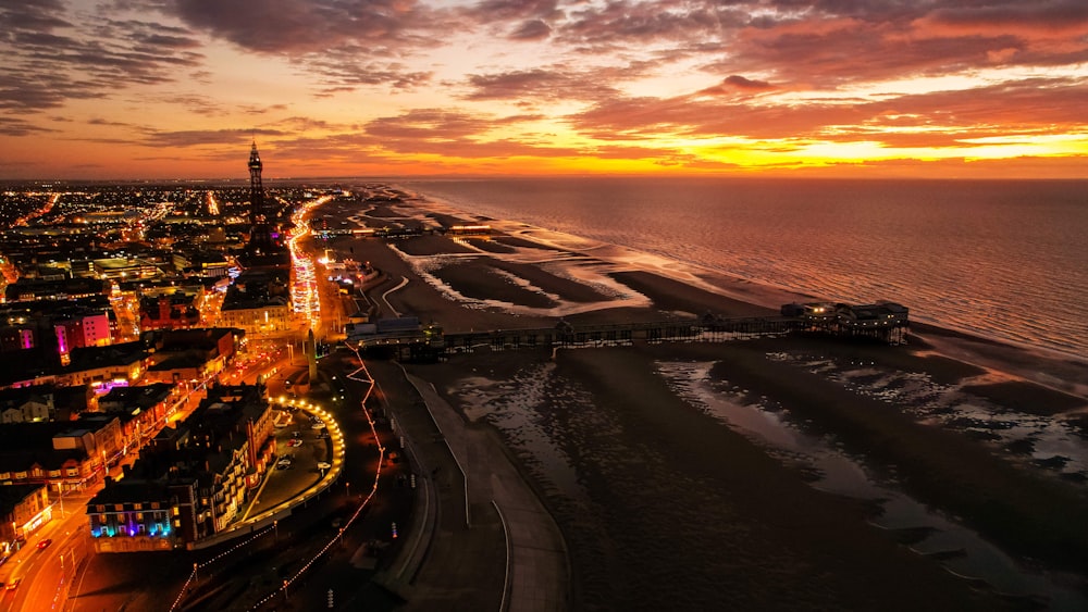 an aerial view of a beach at sunset