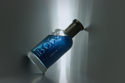 a bottle of booze sitting on a wall
