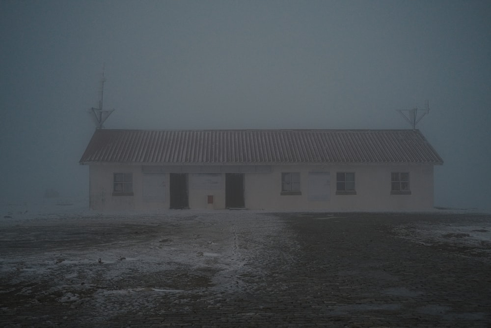 a white building in the middle of a foggy day