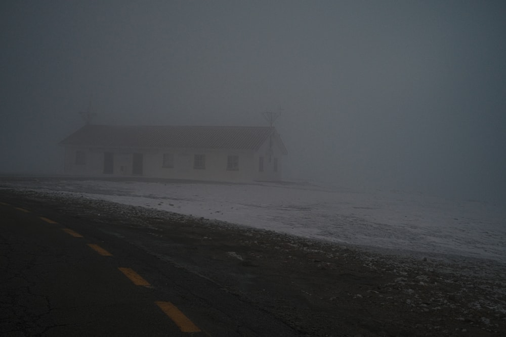 a church in the middle of a foggy road