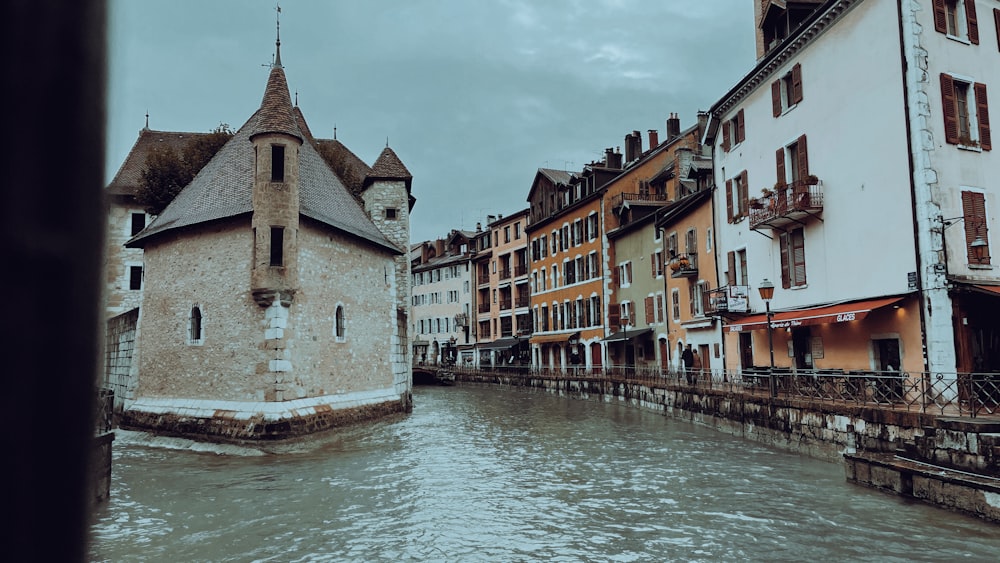 a river running through a city next to tall buildings