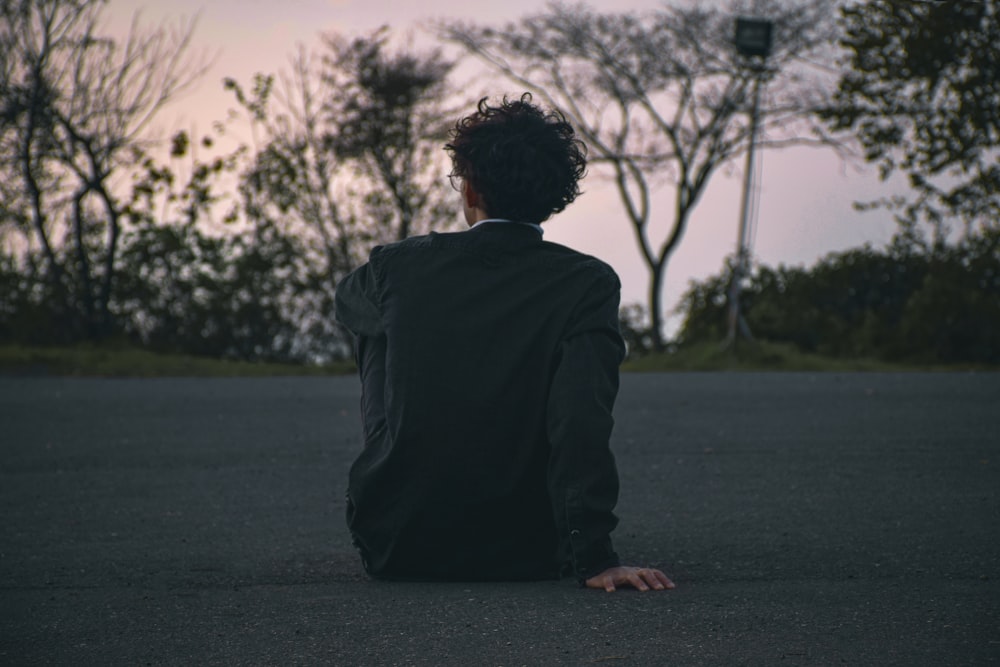 a person sitting in the middle of a road