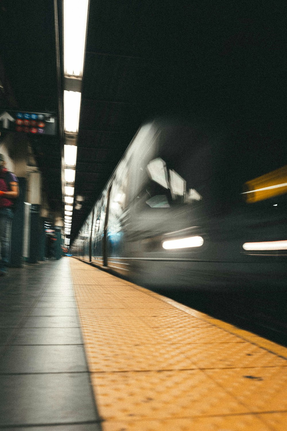a blurry photo of a train at a train station