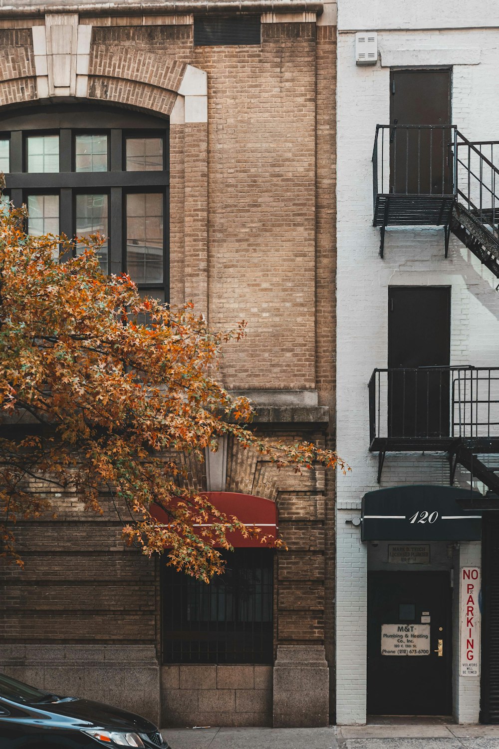 a fire hydrant sitting next to a tall brick building