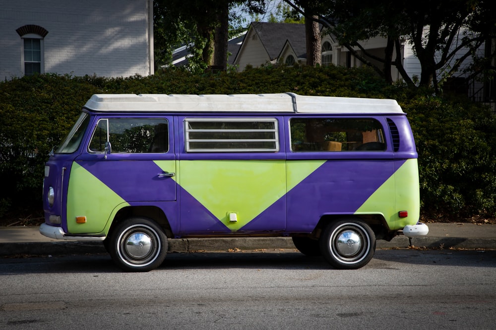 a purple and green van parked on the side of the road