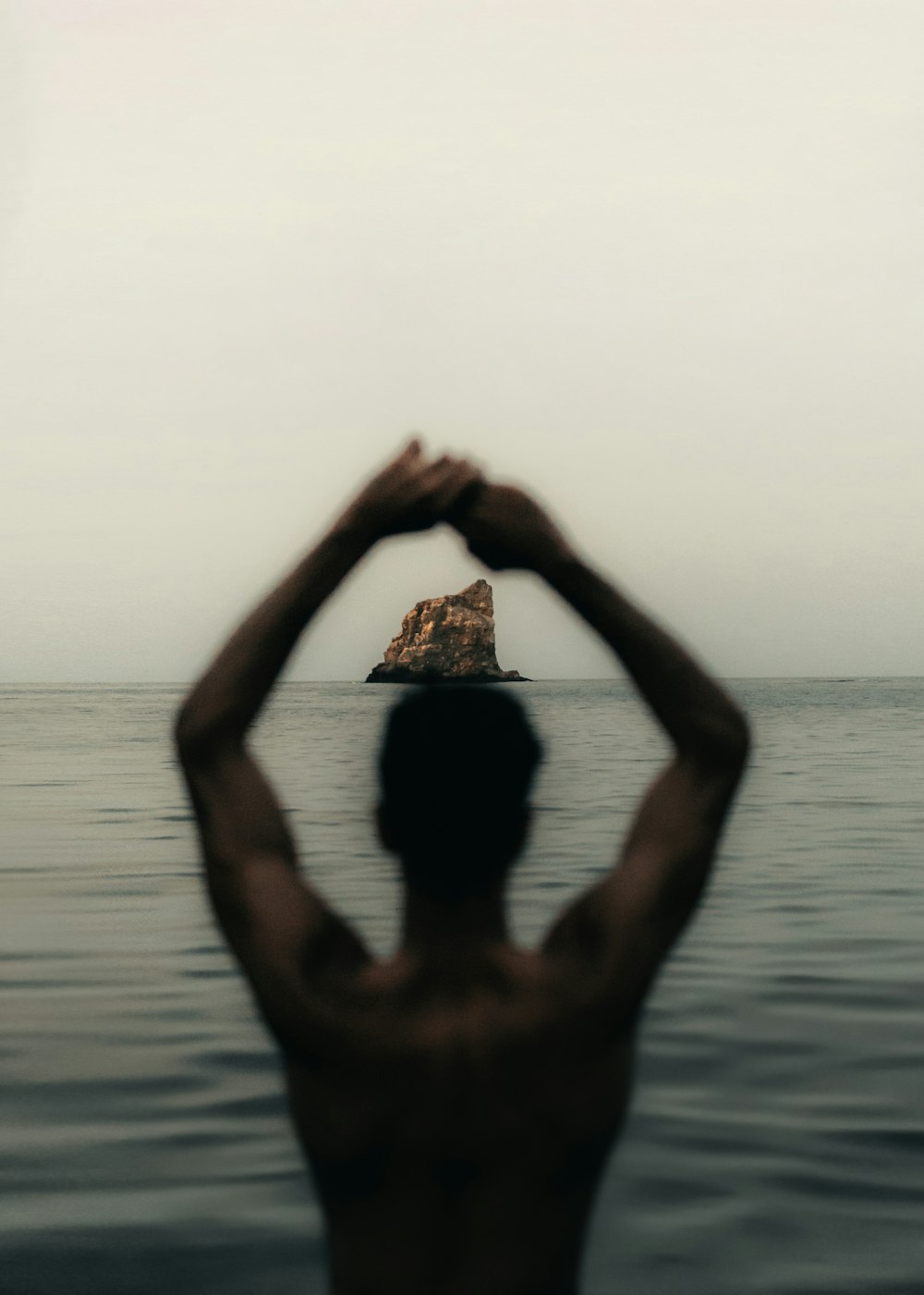 a man standing in the middle of a body of water