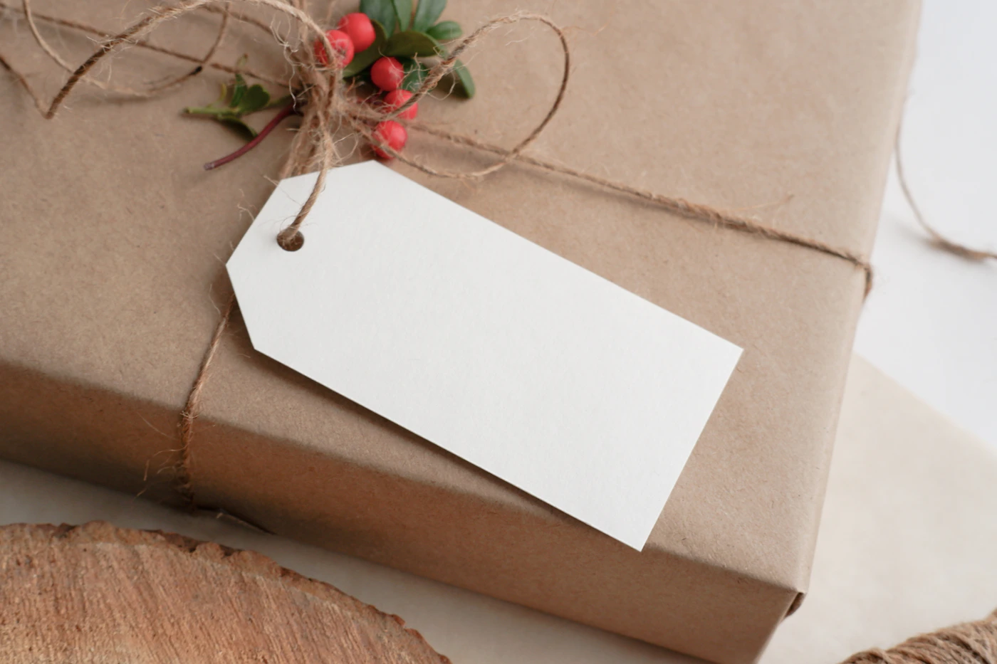 Gift wrapped in brown paper with natural twine and a simple botanical detail