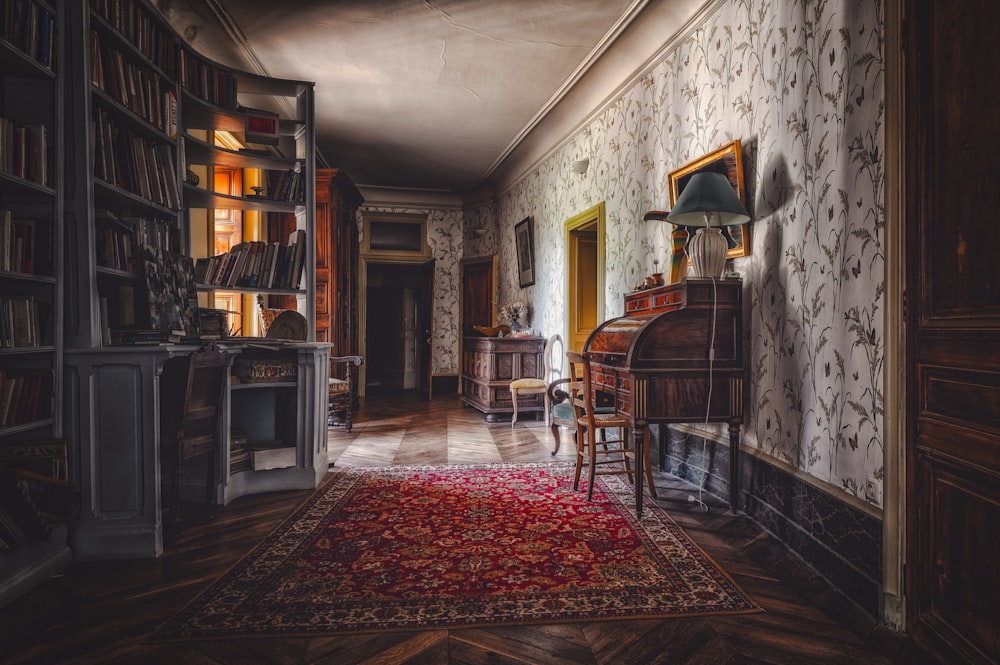 a room with a rug, a chair, a desk and a bookcase