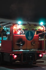 a fire truck with lights on driving down a street