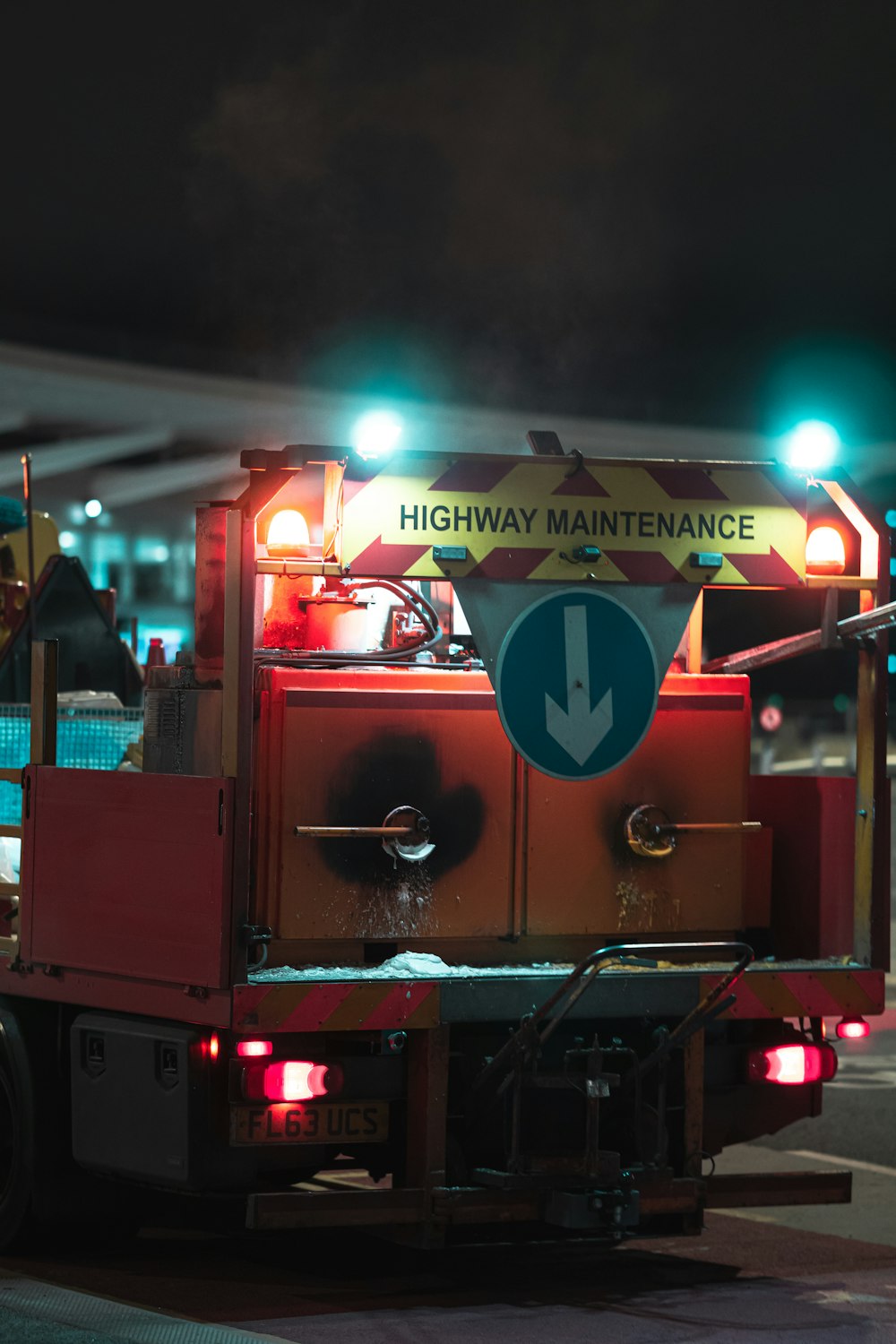 a fire truck with lights on driving down a street