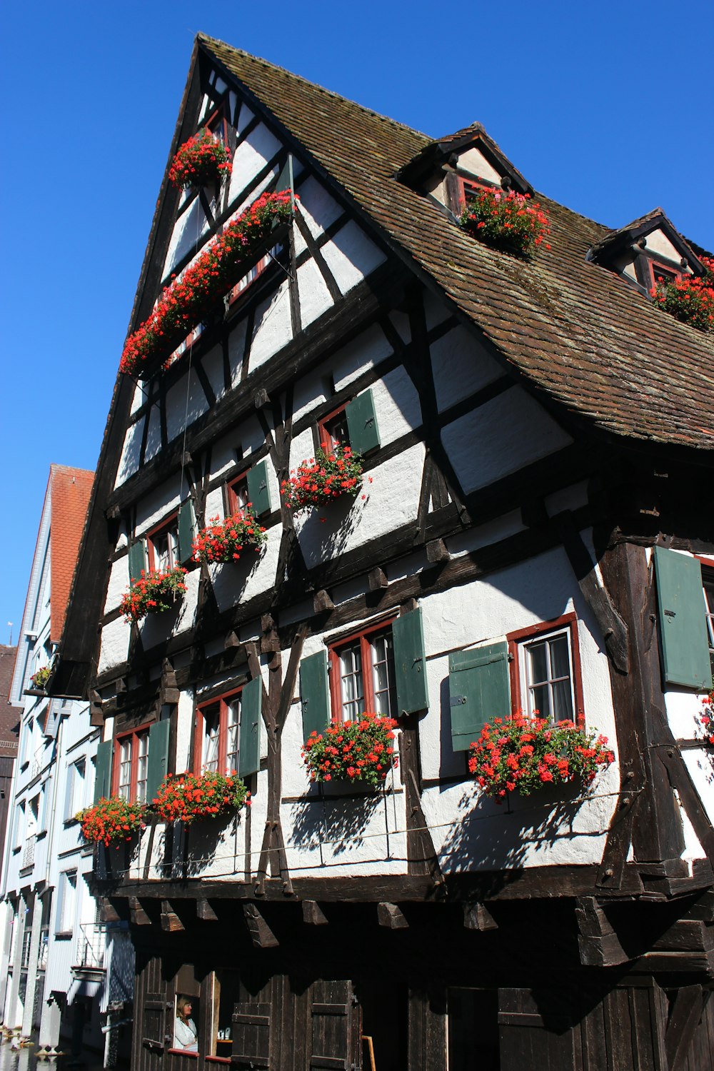 a building with flowers on the windows and shutters