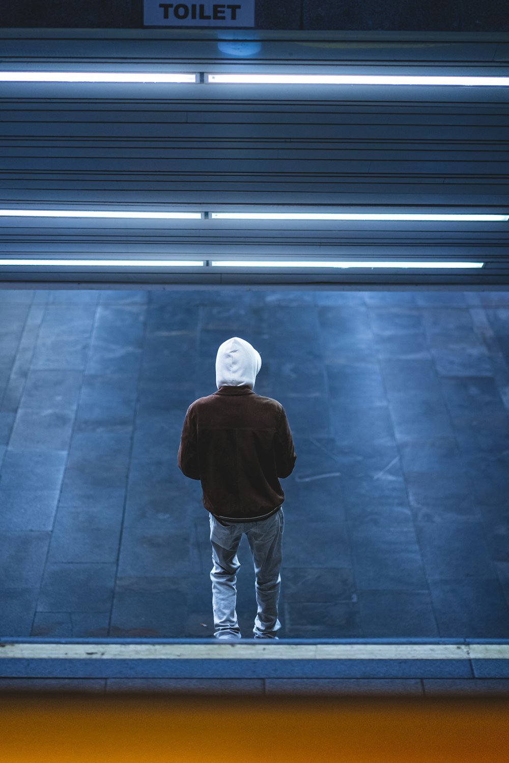 a man standing in front of a toilet