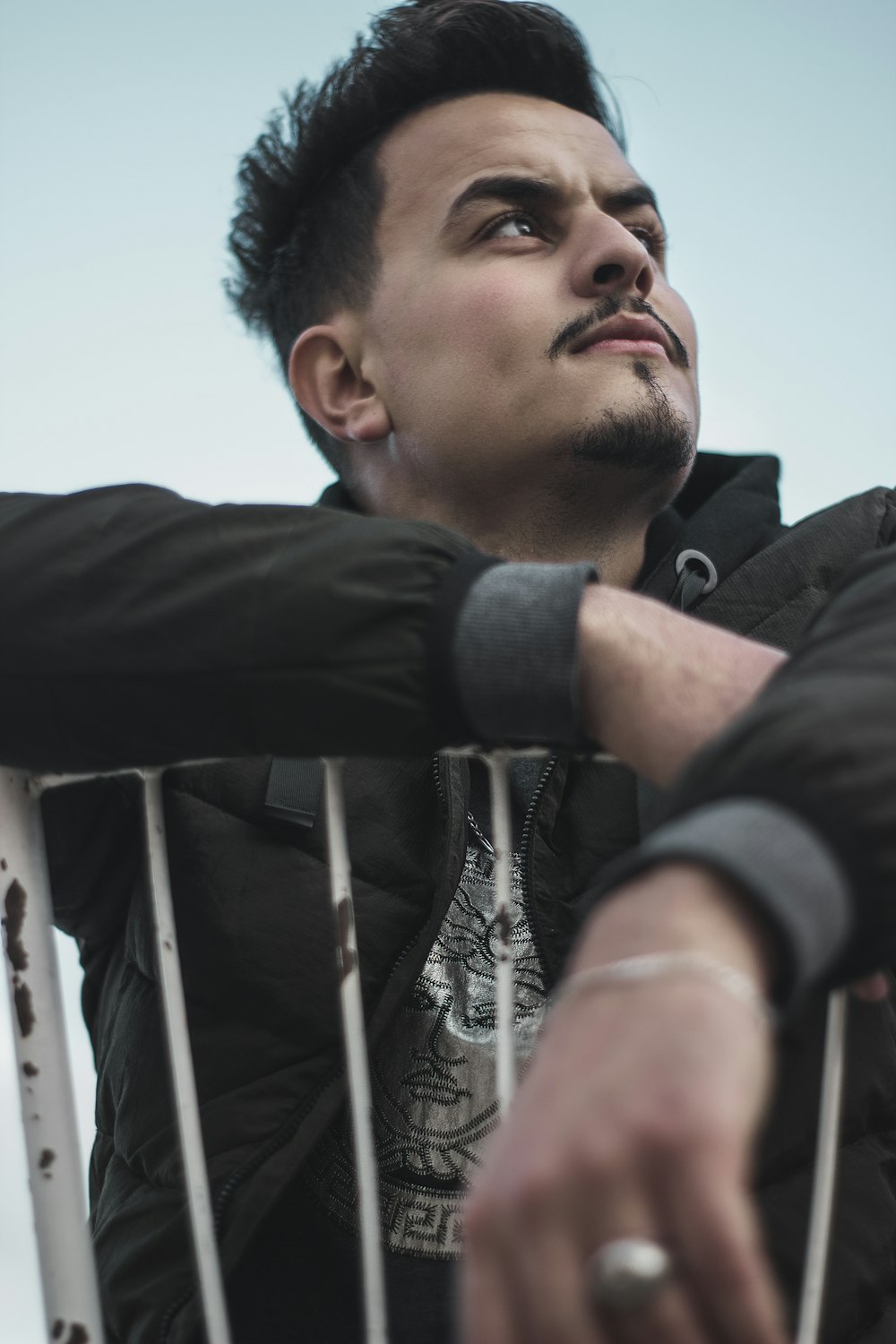 a man sitting on a chair with his arms crossed