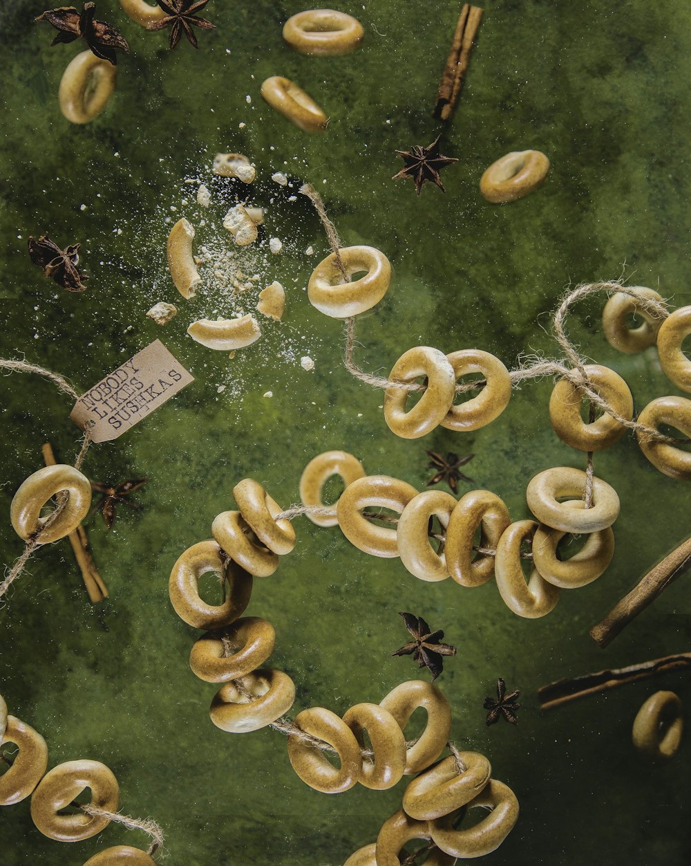 a painting of a bunch of rings on a green surface