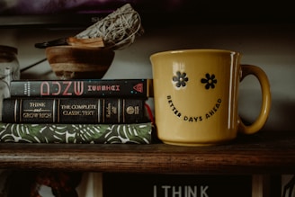 a stack of books sitting on top of a wooden shelf