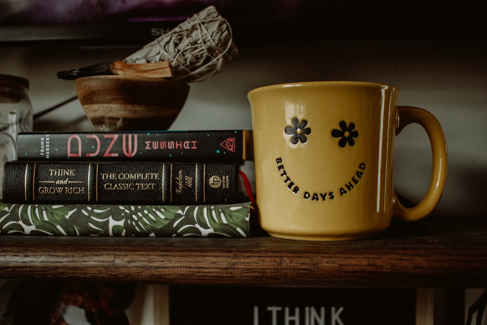 a stack of books sitting on top of a wooden shelf