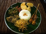 a green plate topped with lots of food
