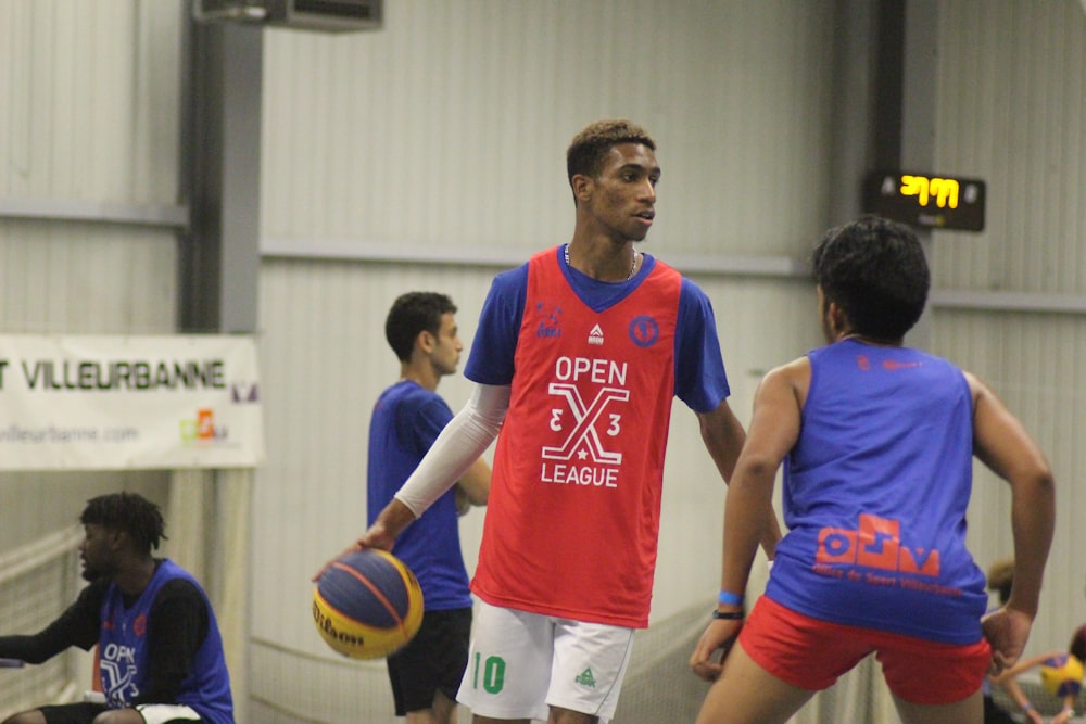 a group of young men playing a game of basketball