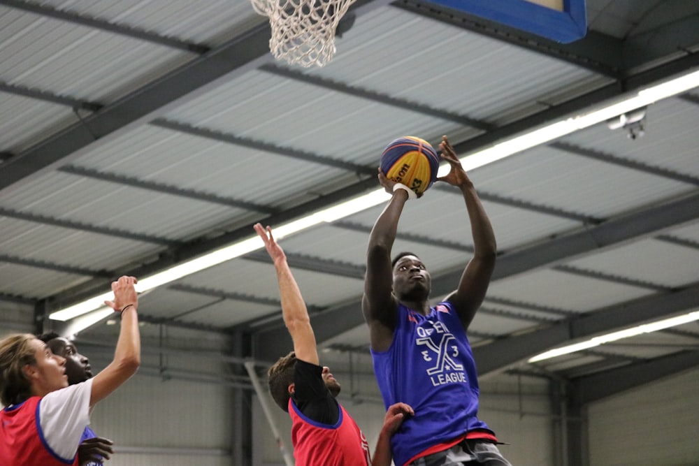 a group of young men playing a game of basketball