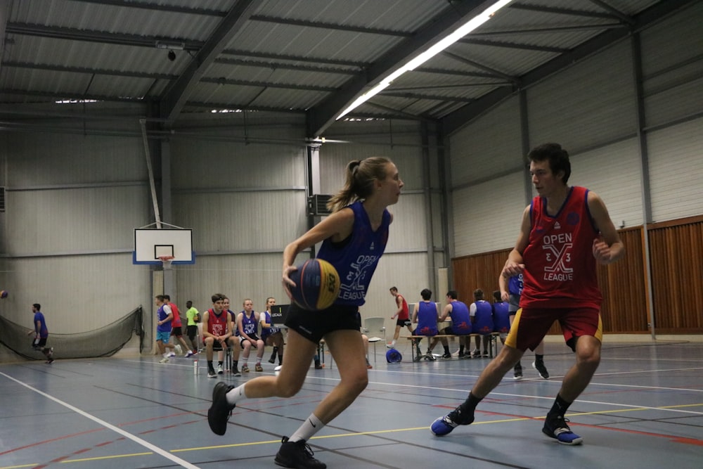 a group of young people playing a game of basketball