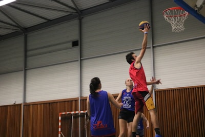 a group of young men playing a game of basketball