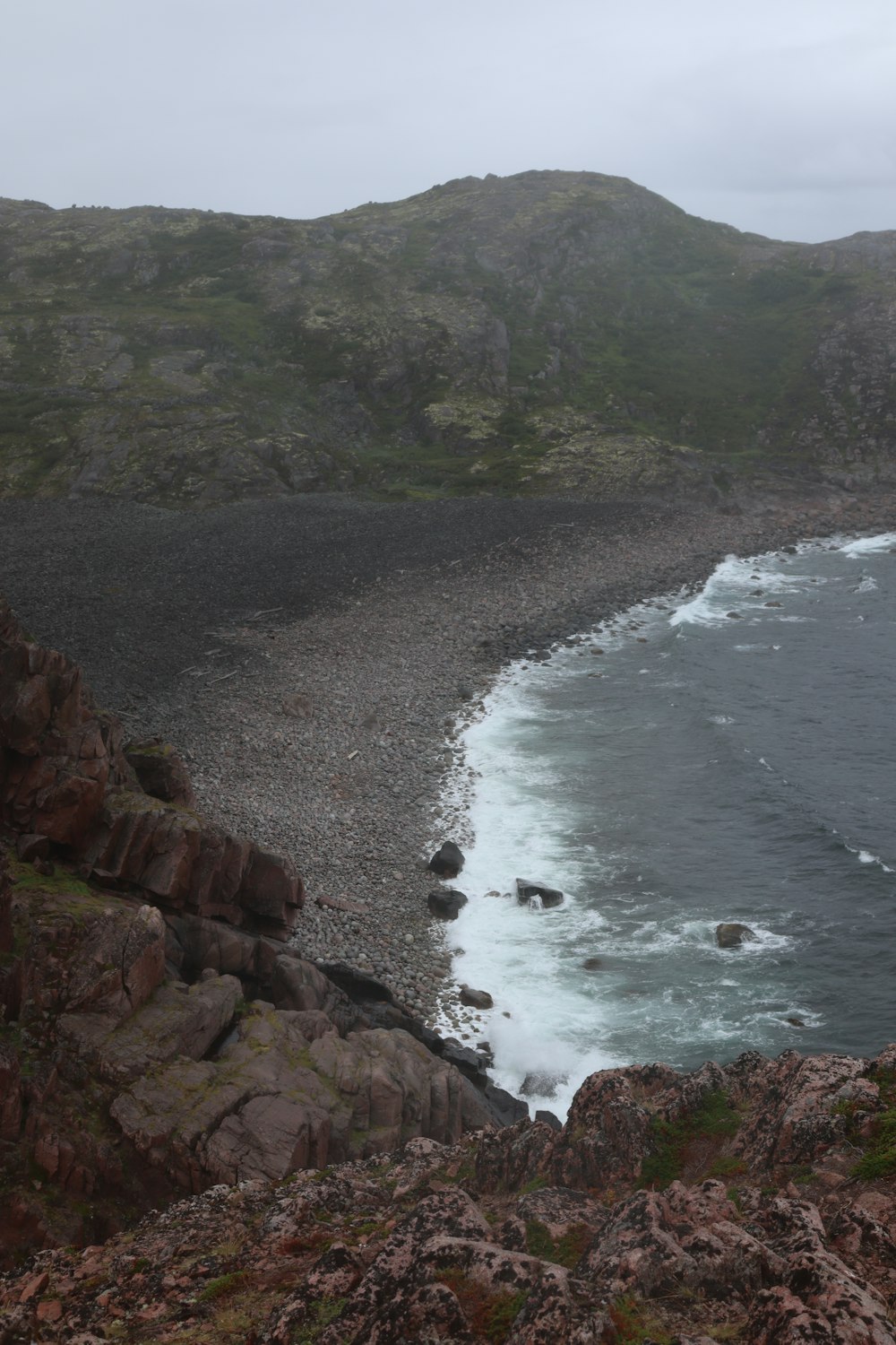 a view of the ocean from a rocky cliff