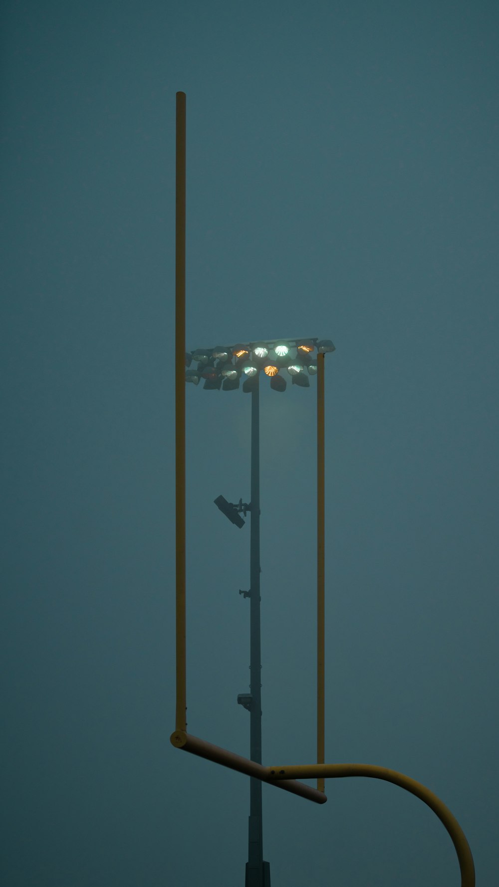 a tall light pole with a street light on top of it