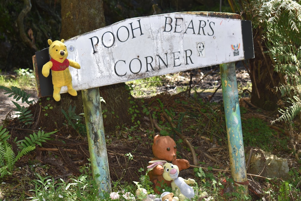 a sign that says pooh bears corner with stuffed animals