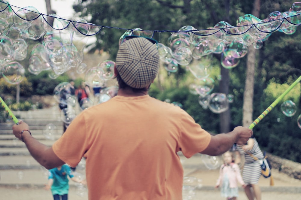 a man is blowing bubbles on the street