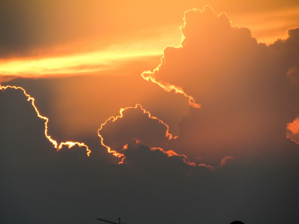 a plane is flying in the sky at sunset