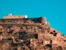 a very tall building on top of a hill