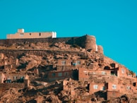 a very tall building on top of a hill