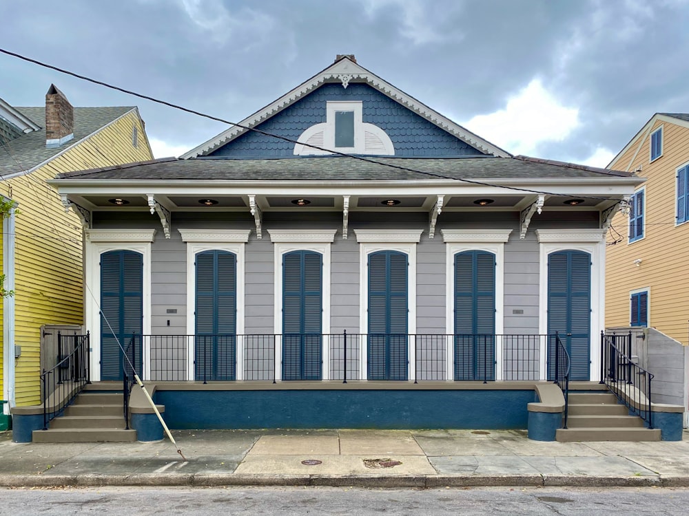 a small blue and white house with blue shutters