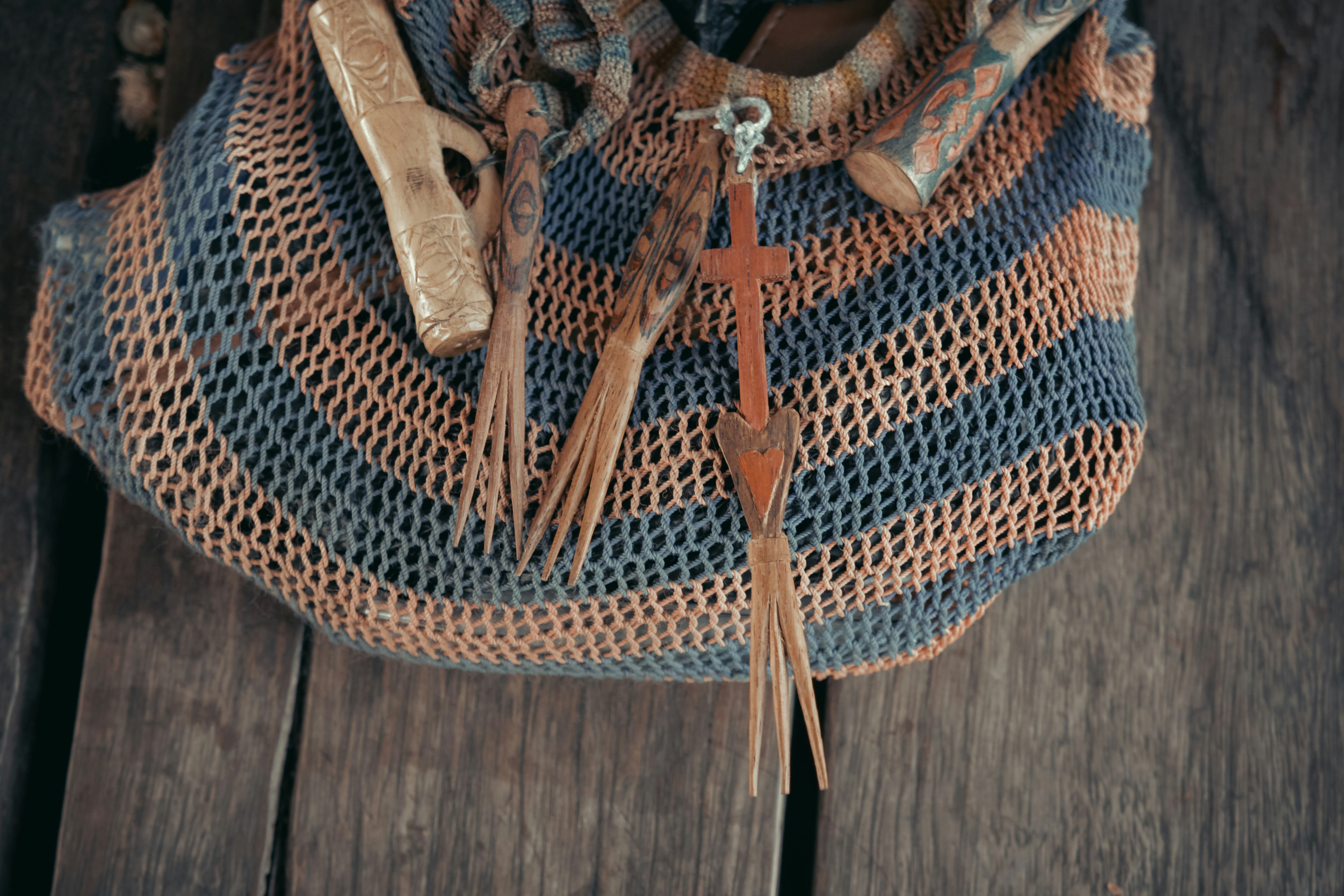 a bag with a cross on it sitting on a wooden floor