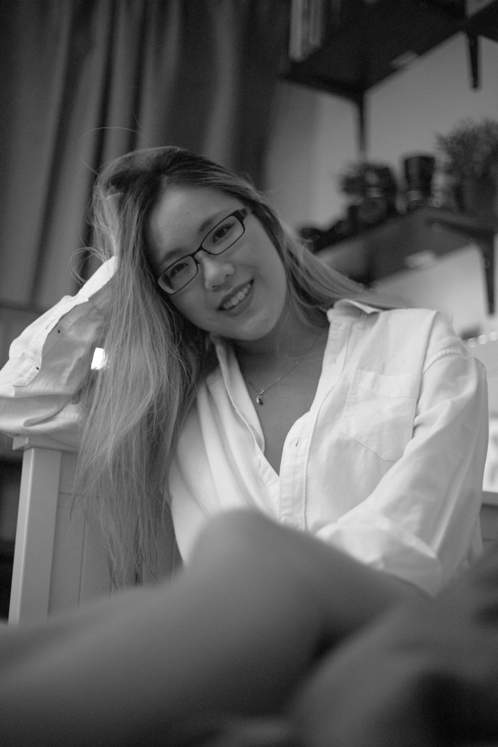 a black and white photo of a woman wearing glasses