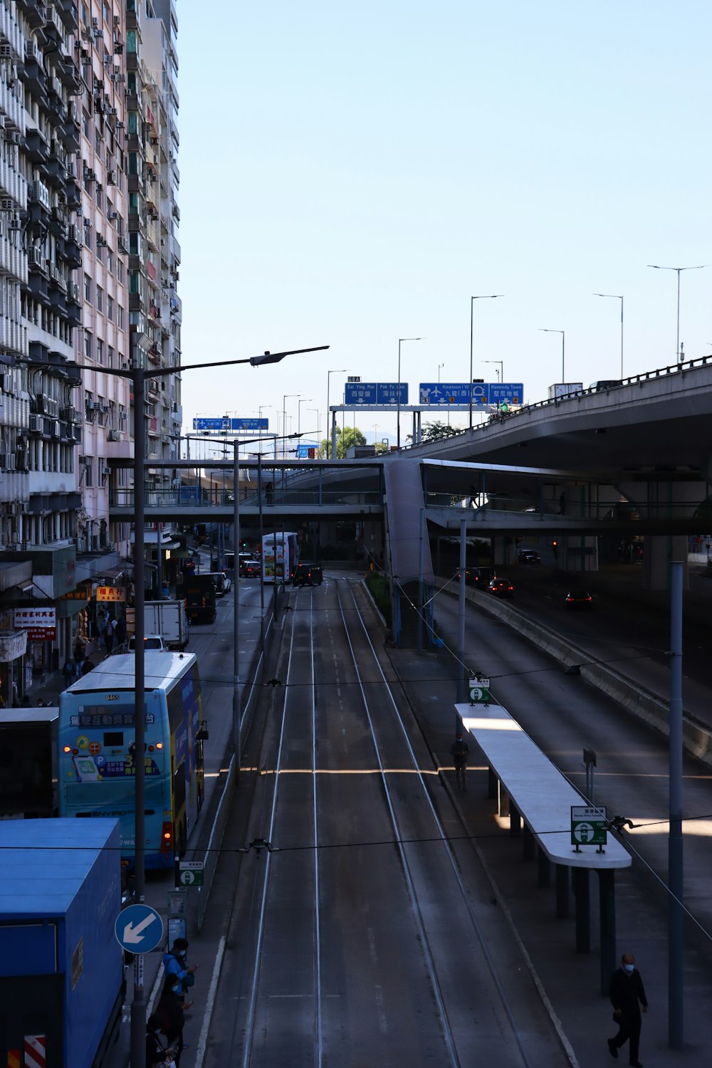 a city street filled with lots of traffic next to tall buildings