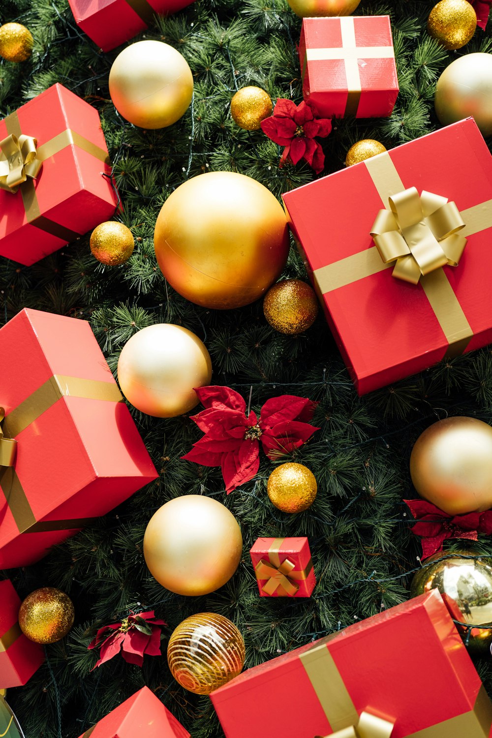 a christmas tree with lots of red and gold presents