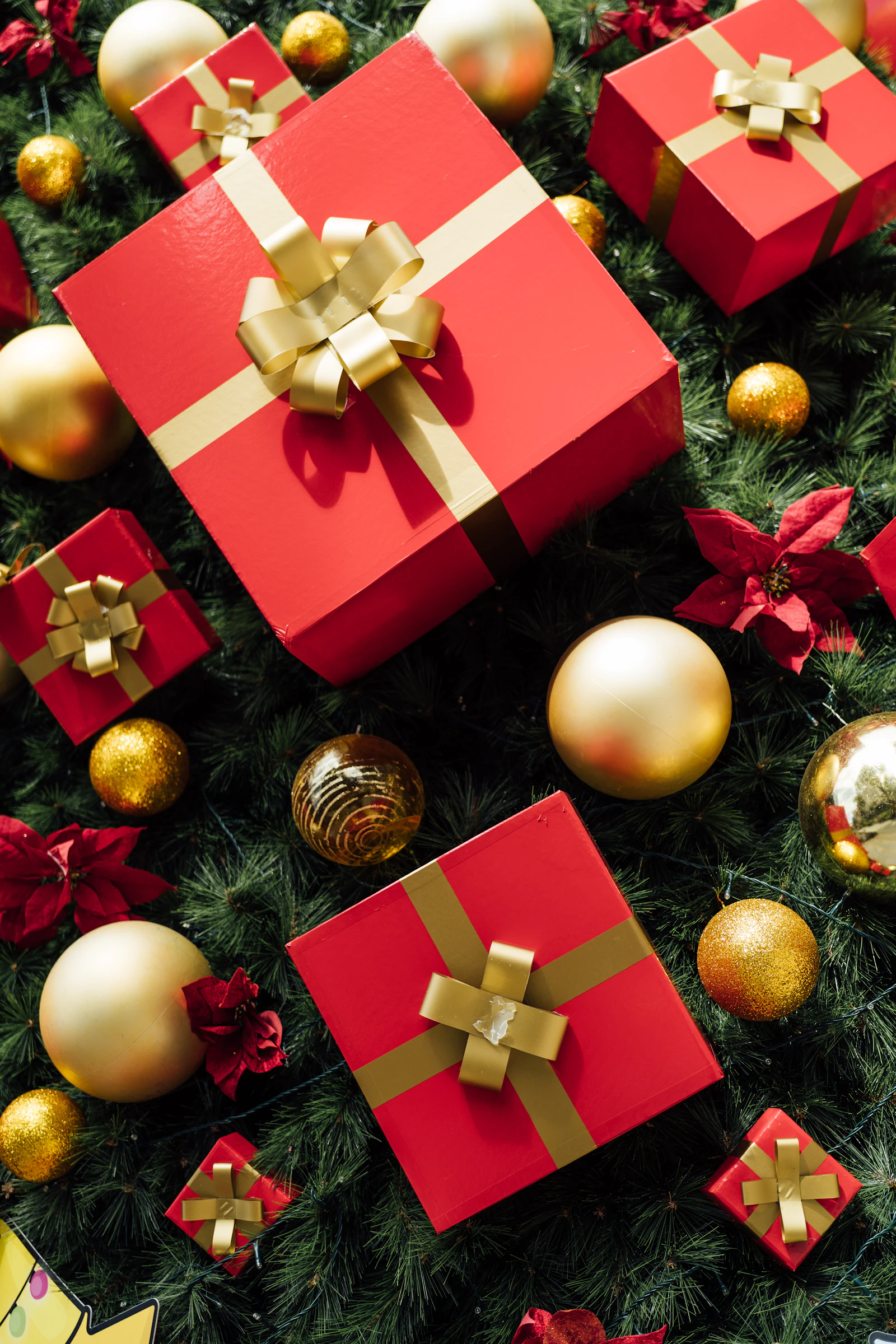 A Christmas tree with red and gold presents underneath
