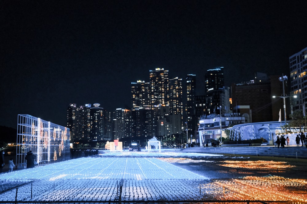 a city at night with a lot of lights on the ground