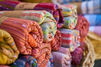 a pile of colorful towels sitting on top of a table