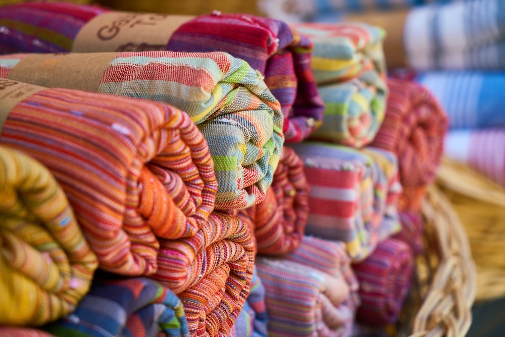 a pile of colorful towels sitting on top of a table