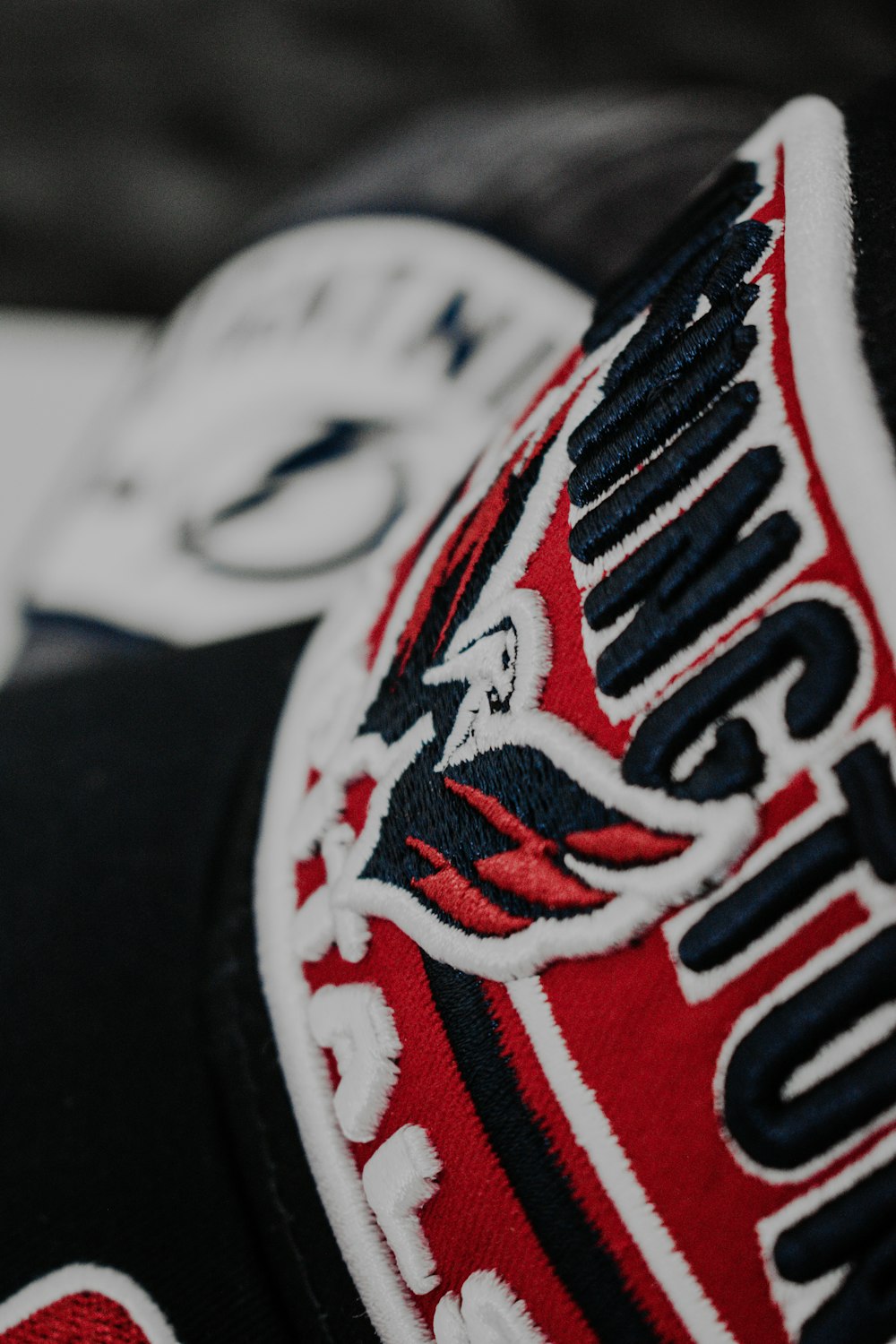 a close up of a black and red hat