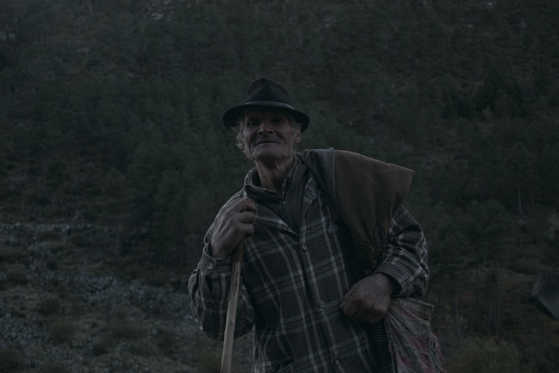 an old man with a hat and a cane