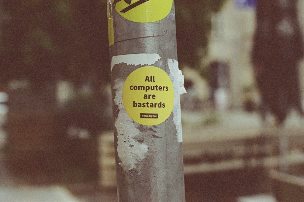 a pole with a bunch of stickers on it