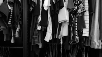 a closet filled with lots of different types of shirts